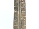 a brown vase that is sitting on a white surface