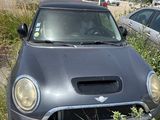 two cars parked next to each other in the grass