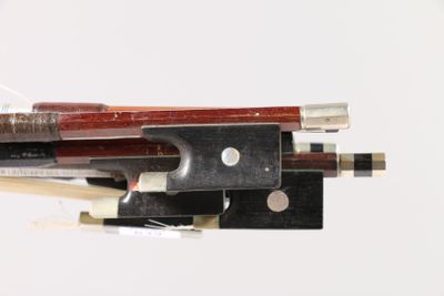 a close up of a violin bow with a bow rest
