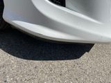 a close up of a white car ' s bumper and front bumper