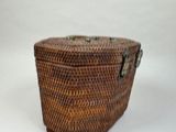 a wicker box with a handle on a white background