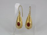 gold plated earrings with a red stone in the middle