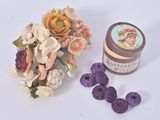 a small jar of cream next to a bouquet of flowers