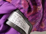 the label on a purple jacket that is attached to a purple jacket