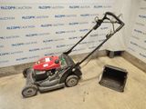 an image of a small lawn mower in a garage