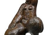 sculpture of a woman sitting on her back with her legs crossed