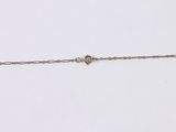 a close up of a silver chain with a heart on it