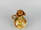 a glass vase with a flower in it on a table