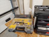 two tool boxes sitting next to each other on a table