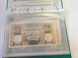 three bills in a clear plastic case on a table