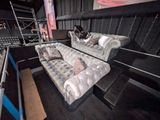 two couches that are sitting in the middle of a stage