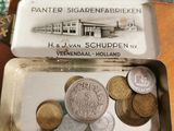 a tin of coins sitting on top of a table