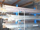 a lot of steel bars stacked up in a storage area