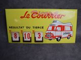 panneau jaune sur lequel figure un bus rouge et blanc et où est inscrit « Le Couver »
