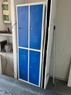 two blue lockers in the corner of a room