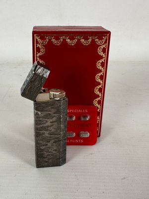 a lighter that is sitting next to a red box