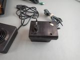 a small power supply sitting on a desk next to a laptop
