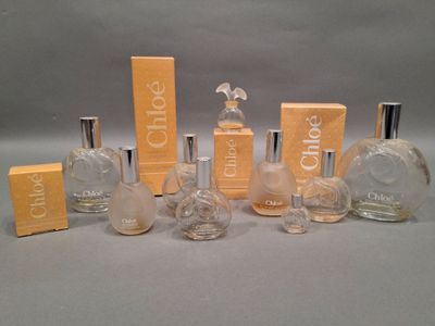several bottles of perfume sitting on top of a table next to each other