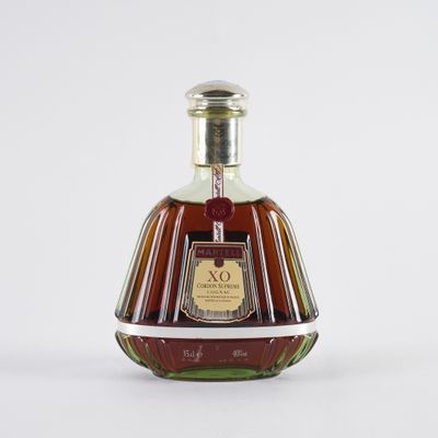 an image of a bottle of brandy sitting on a white surface