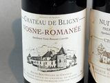 two bottles of wine sitting next to each other on a table