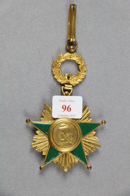 un gros plan d'une médaille d'or ornée d'une étoile verte