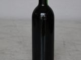 a bottle of wine sitting on a marble table