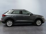 a grey volkswagen suv is parked in a garage
