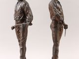 pair of bronze figurines of a man and a woman