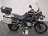 bmw motorcycle parked in a garage with luggage on the back of it