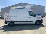 the white van is parked in front of a building with a crane on top of it