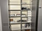 a large open book shelf in the corner of a room