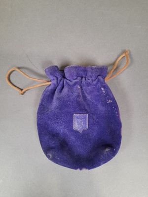 an image of a small purple bag with a tag on it