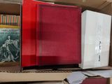 many books in a box on a table