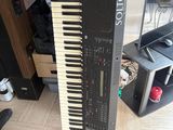 a piano that is sitting on the floor next to a keyboard