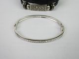a close up of a bracelet and a watch on a table