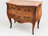 a small chest of drawers with a marble top