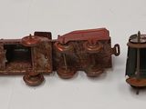 three toy trains sitting next to each other on a white surface