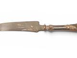 an antique silver plated knife on a white surface with a white background
