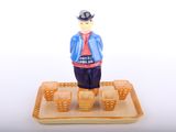 a figurine of a man standing on top of a tray