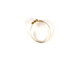 an image of a gold ring on a white surface