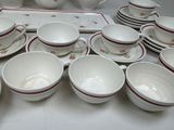 many cups and saucers sitting on a table