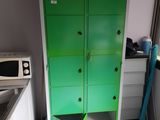 a green cabinet in the corner of a room