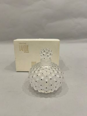 an image of a small glass bottle with a box in the background