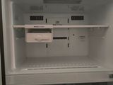 an open refrigerator with the door open in a kitchen