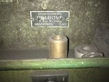 an old machine with a sign on the side of it