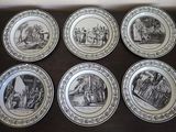 six black and white plates with pictures of people on them on a table