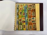 an open book with stamps on it sitting on a table
