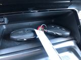 two remote controls in the center console of a car