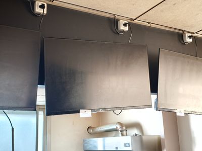 deux téléviseurs suspendus au plafond au-dessus d'une cuisinière
