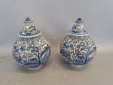 pair of blue and white vases with birds and flowers on them